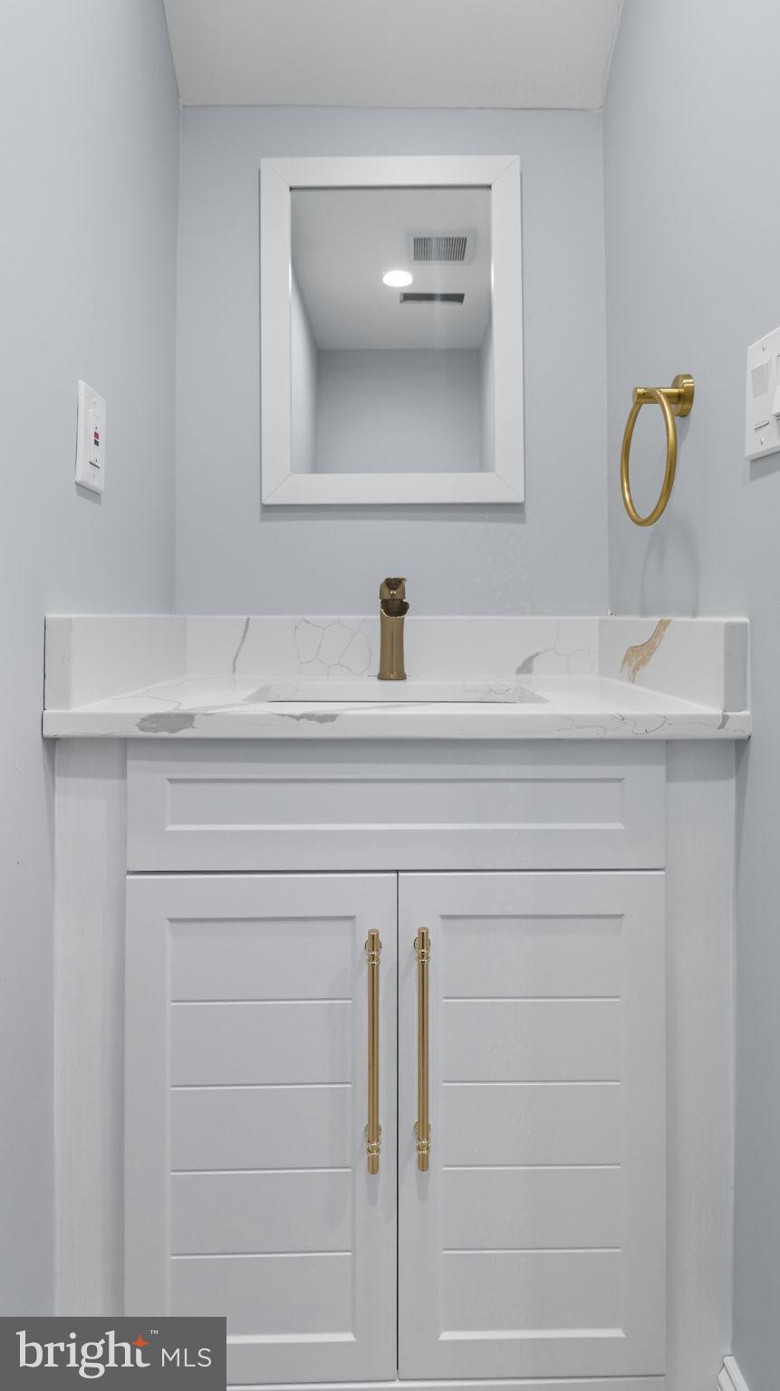 2238 15th Street Northeast Washington, DC 20018 - Photo 15 of 38 a bathroom with a sink and a mirror