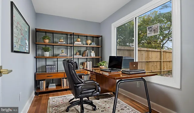a work room with furniture and a floor to ceiling window
