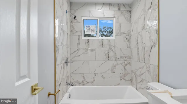 a bathroom with a bathtub and shower