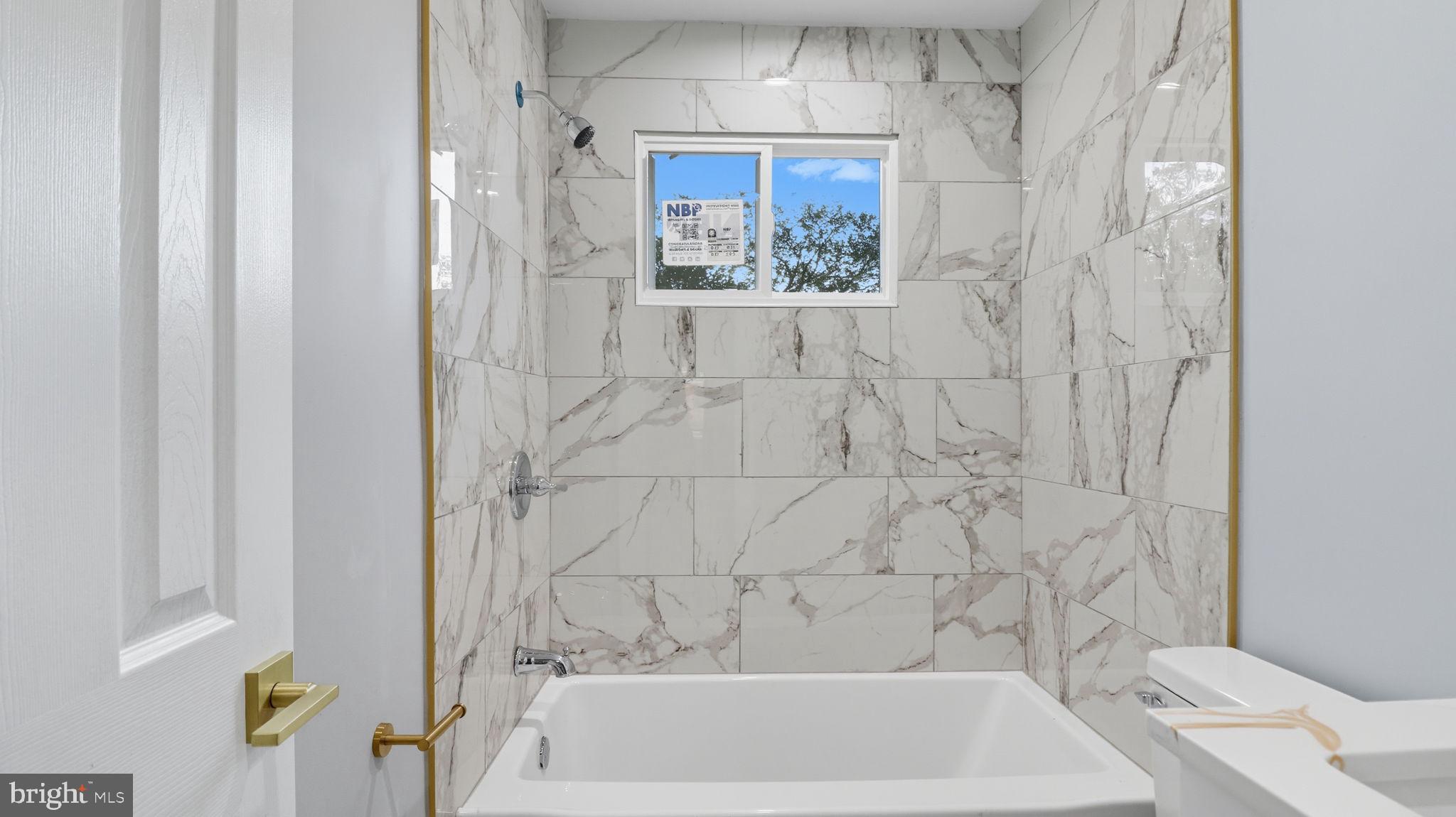2238 15th Street Northeast Washington, DC 20018 - Photo 23 of 38 a bathroom with a bathtub and shower