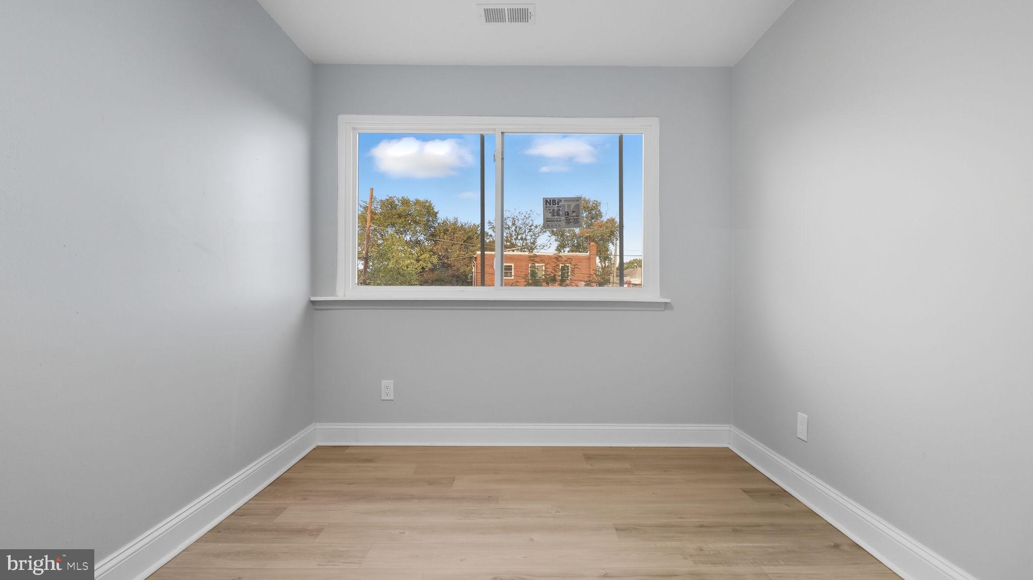 2238 15th Street Northeast Washington, DC 20018 - Photo 26 of 38 a view of an empty room with wooden floor and a window