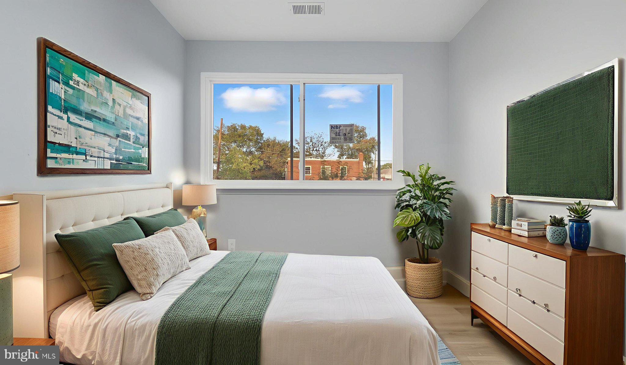 2238 15th Street Northeast Washington, DC 20018 - Photo 27 of 38 a bedroom with a bed and a flat screen television
