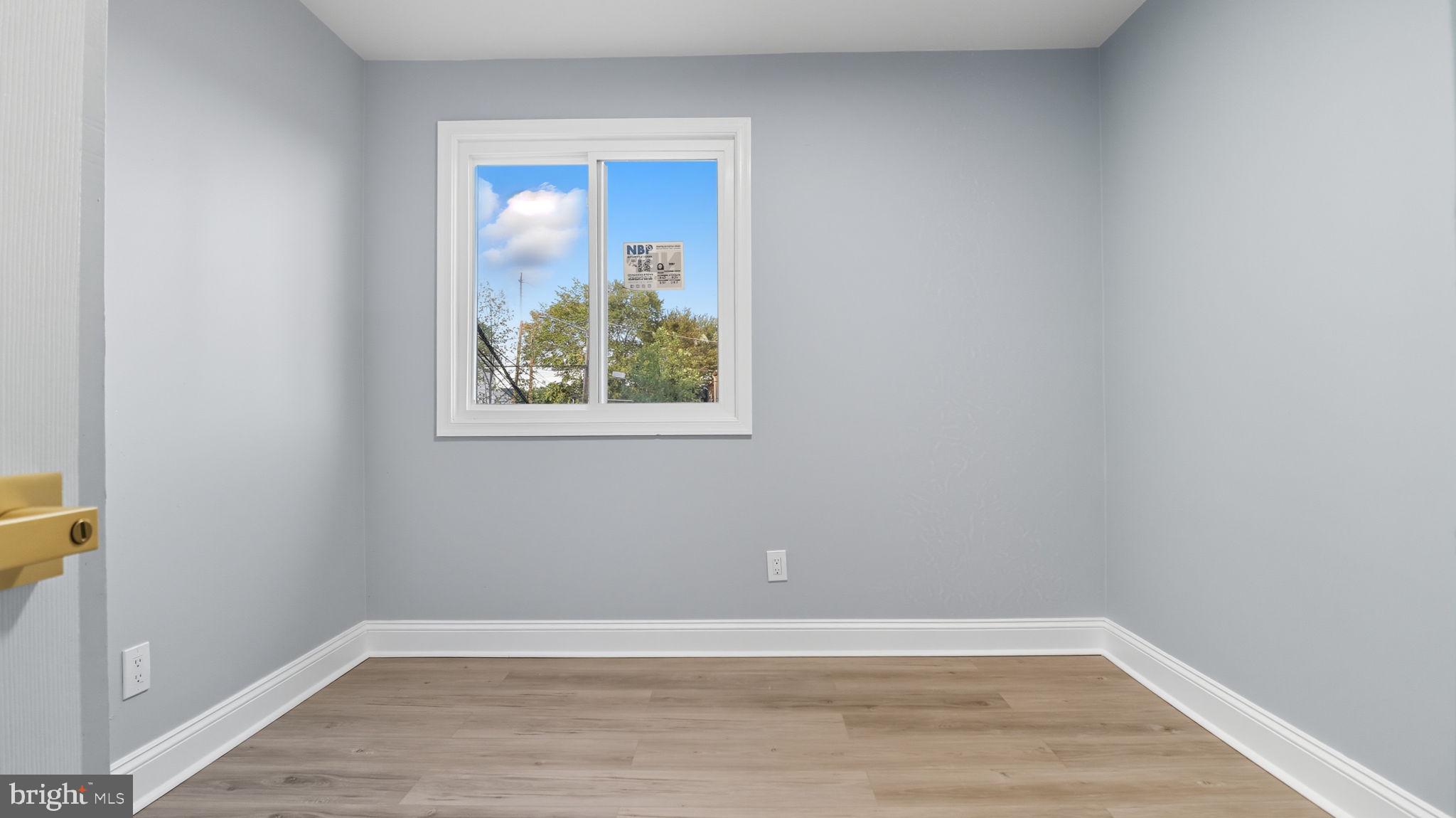 2238 15th Street Northeast Washington, DC 20018 - Photo 30 of 38 a view of an empty room with wooden floor and a window