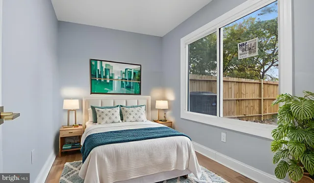 a bedroom with a large bed and a large window with outer view