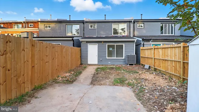 a view of a house with wooden fence
