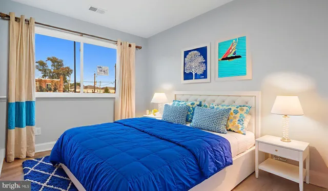 a bedroom with a bed and painting on the wall