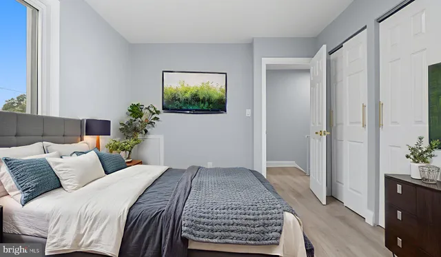 a bedroom with a bed and a potted plant