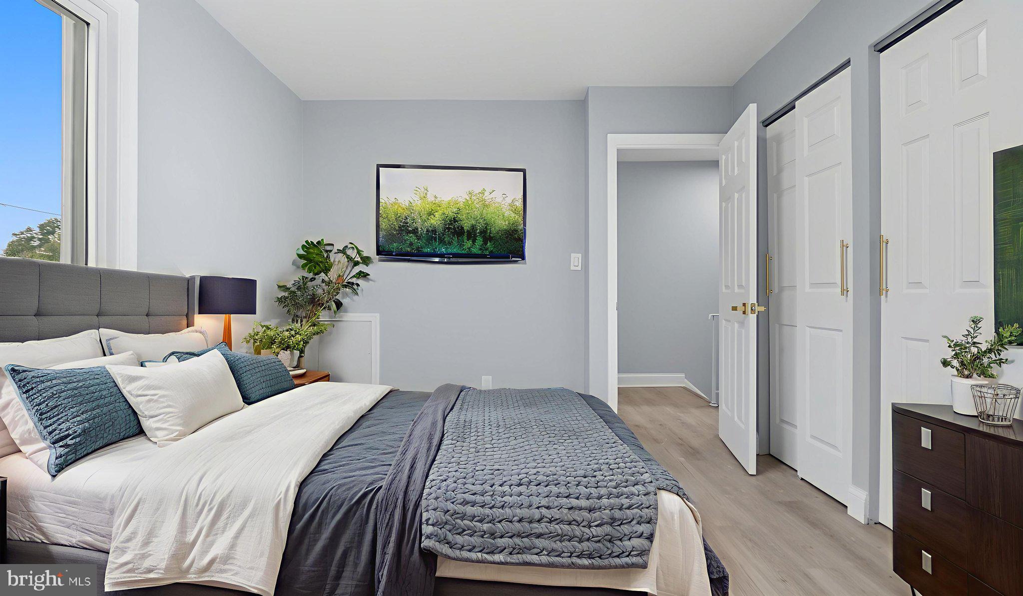 2238 15th Street Northeast Washington, DC 20018 - Photo 6 of 38 a bedroom with a bed and a potted plant