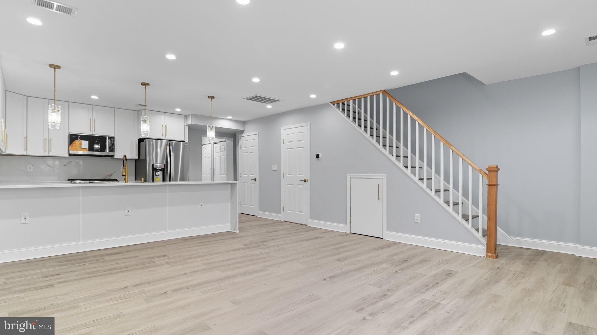 2238 15th Street Northeast Washington, DC 20018 - Photo 8 of 38 a view of kitchen with kitchen island microwave and wooden floor