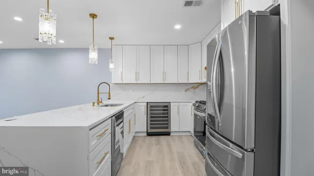 a kitchen with stainless steel appliances a refrigerator sink and cabinets