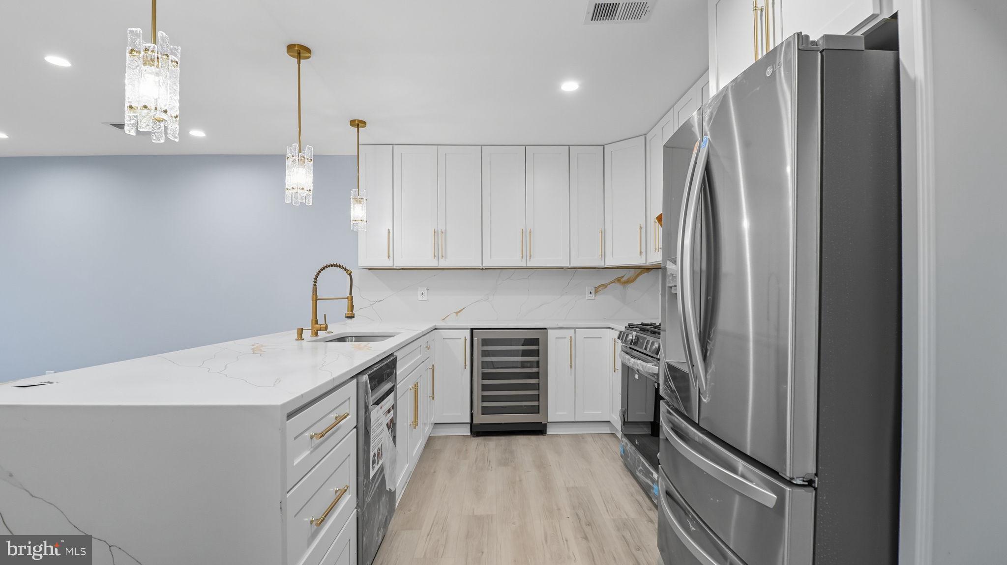 2238 15th Street Northeast Washington, DC 20018 - Photo 9 of 38 a kitchen with stainless steel appliances a refrigerator sink and cabinets
