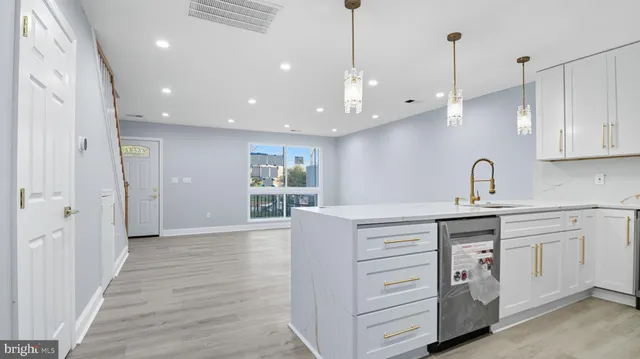 a kitchen with a sink stainless steel appliances and cabinets