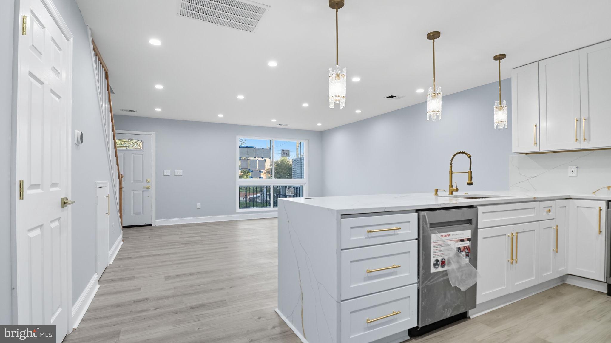 2238 15th Street Northeast Washington, DC 20018 - Photo 10 of 38 a kitchen with a sink stainless steel appliances and cabinets