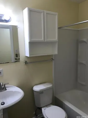 a white toilet sitting next to a bathroom sink