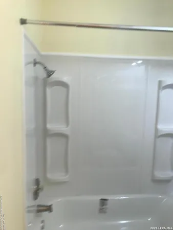 a bathroom with a shower and a toilet