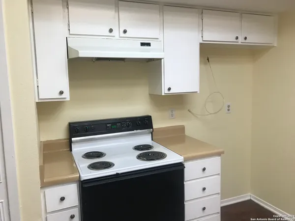 a kitchen with a stove and a cabinets