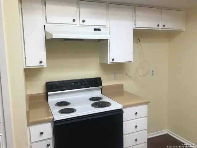 a kitchen with a stove and a cabinets