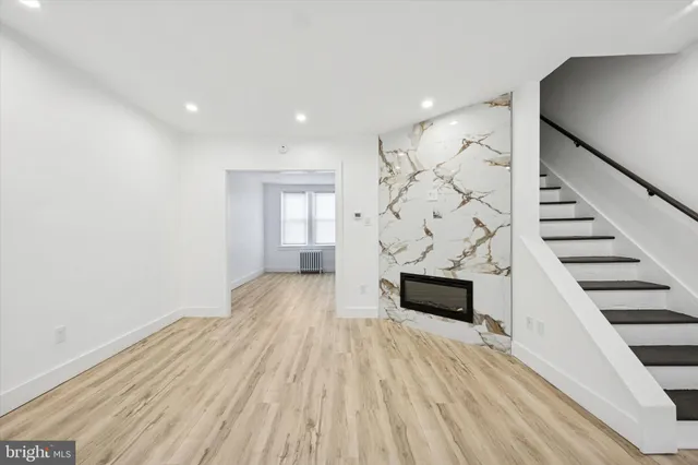 wooden floor in an empty room with a fireplace