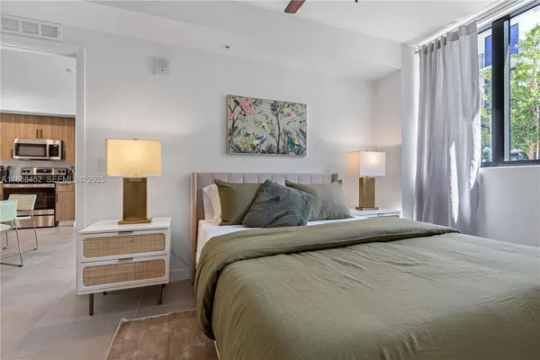 a bedroom with a bed and a lamp on table