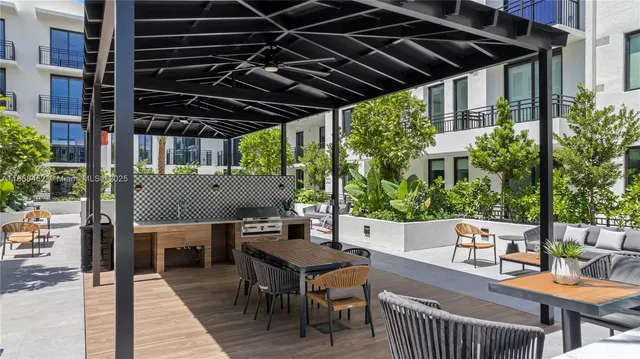 a patio of a house with table and chairs