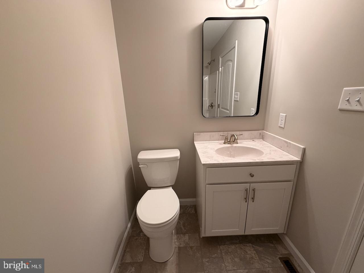 306 Rine Drive Shippensburg, PA 17257 - Photo 13 of 18 a bathroom with a toilet sink and mirror