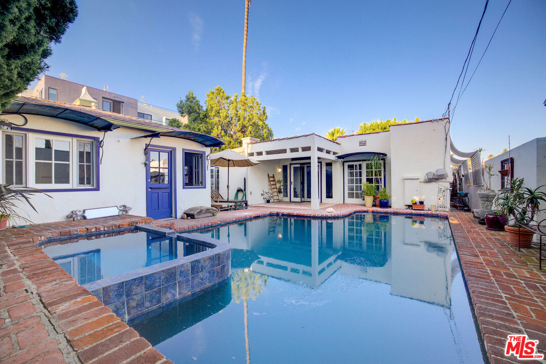 455 South Hamel Road Los Angeles, CA 90048 - Photo 2 of 31 a front view of a house with swimming pool fire pit and chairs
