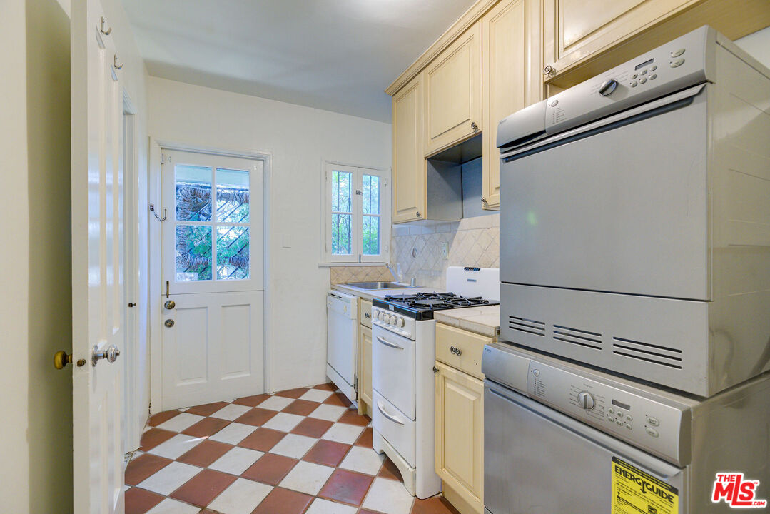 455 South Hamel Road Los Angeles, CA 90048 - Photo 29 of 31 a kitchen with granite countertop cabinets appliances and a window