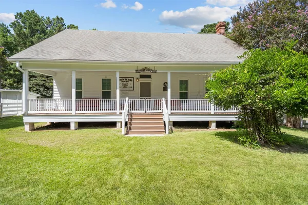 a view of a house with backyard porch and sitting area