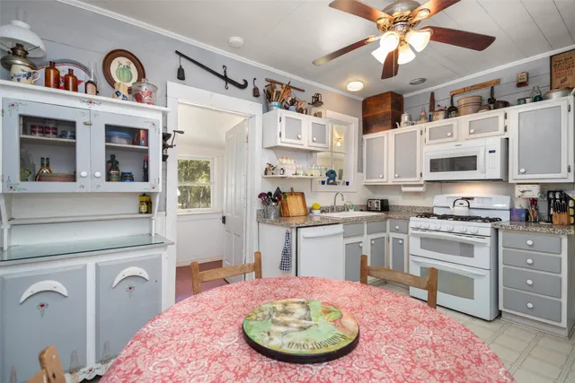 a kitchen with stainless steel appliances kitchen island granite countertop a sink and cabinets