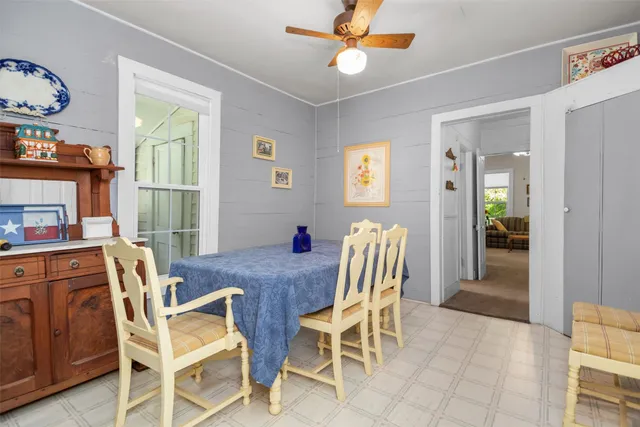 a view of a dining room with furniture and a chandelier