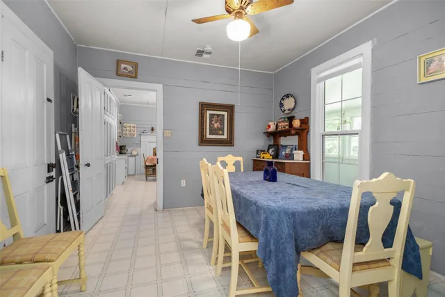 a view of a dining room with furniture and a chandelier