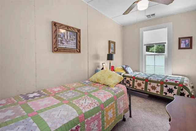 a bedroom with a bed and a baby crib