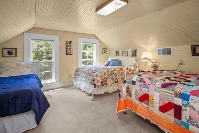 a bedroom with double bed and a window