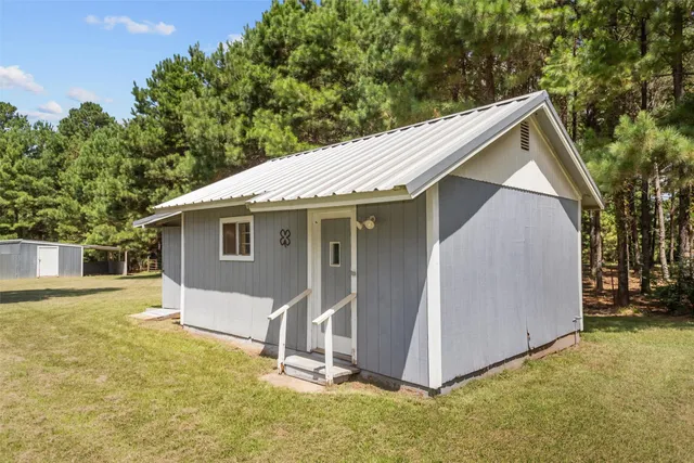 a view of a backyard with a cabin