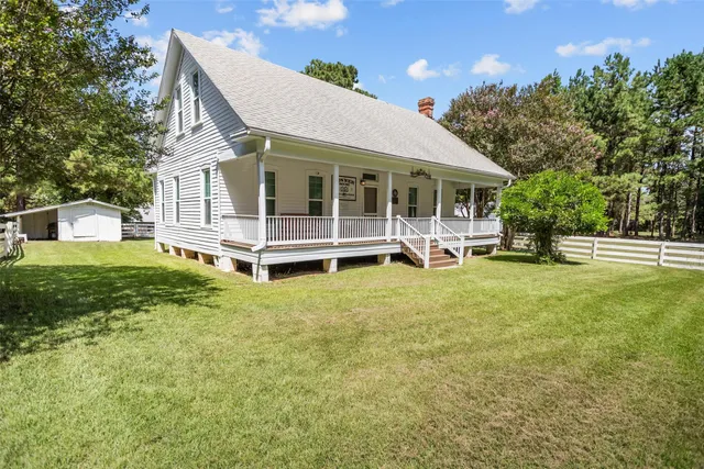 a view of a house with backyard porch and sitting area