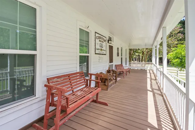 a view of a roof deck with couches and wooden floor
