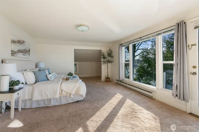 a bedroom with a bed and a painting