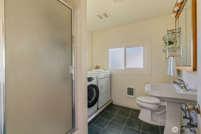 a bathroom with a toilet tub and shower