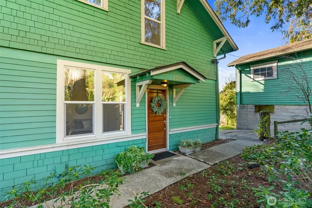 a front view of a house with a garden
