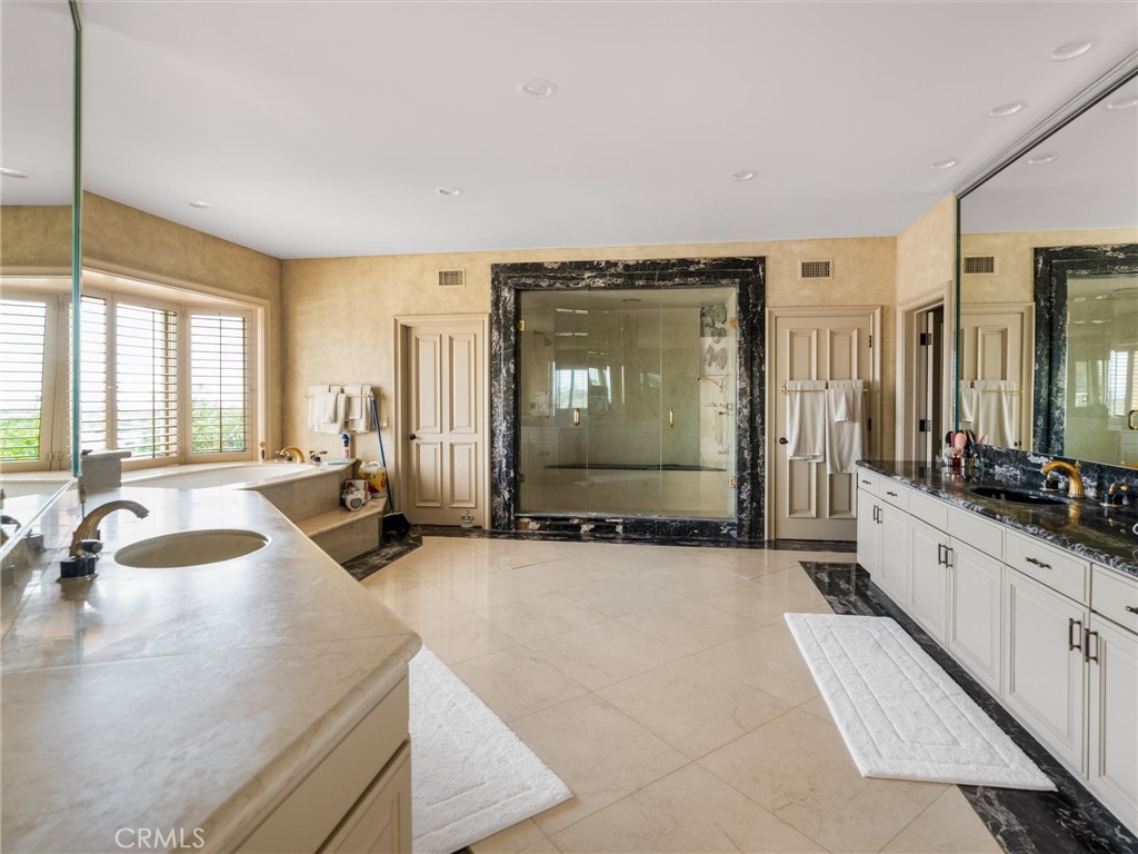 6000 Cavalleri Road Malibu, CA 90265 - Photo 29 of 44 a spacious bathroom with a tub sink and mirror