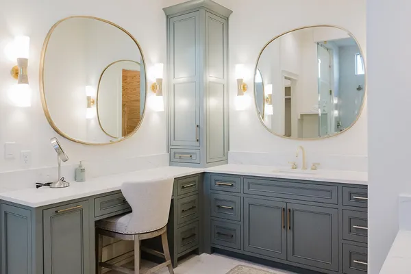 a spacious bathroom with a double vanity sink a toilet and a mirror