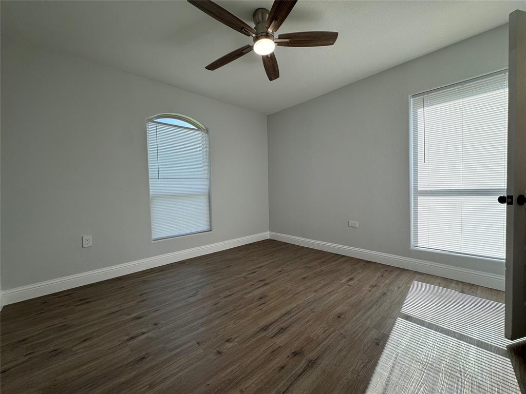 2909 Alexander Avenue Waco, TX 76708 - Photo 19 of 27 Unfurnished room featuring dark wood-type flooring and ceiling fan