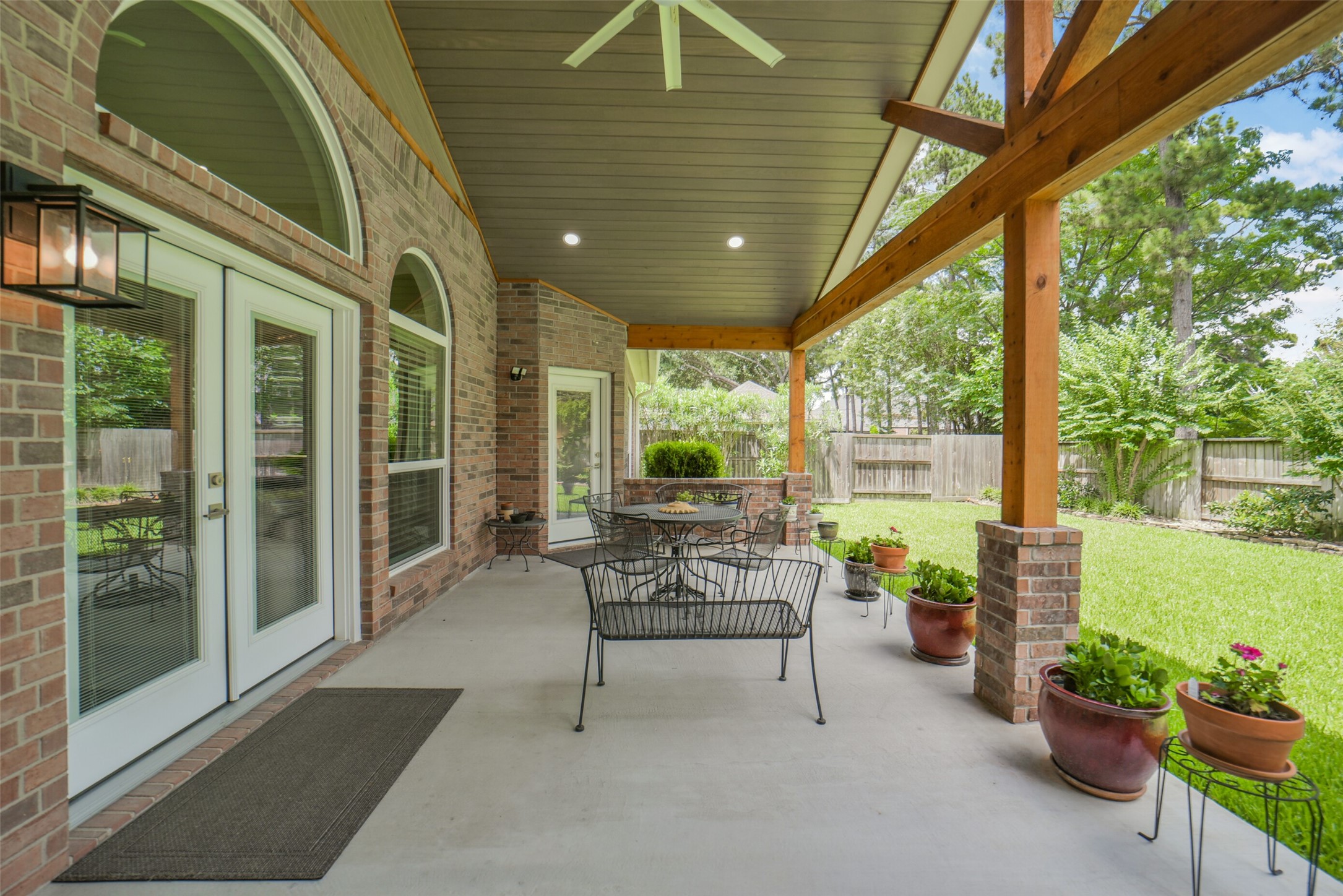 1310 Lambourne Circle Spring, TX 77379 - Photo 43 of 50 French doors lead to the patio looking out on a lush yard and landscaped fence all the way around the back yard