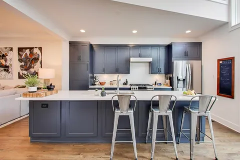 a kitchen with stainless steel appliances granite countertop a center island and a refrigerator
