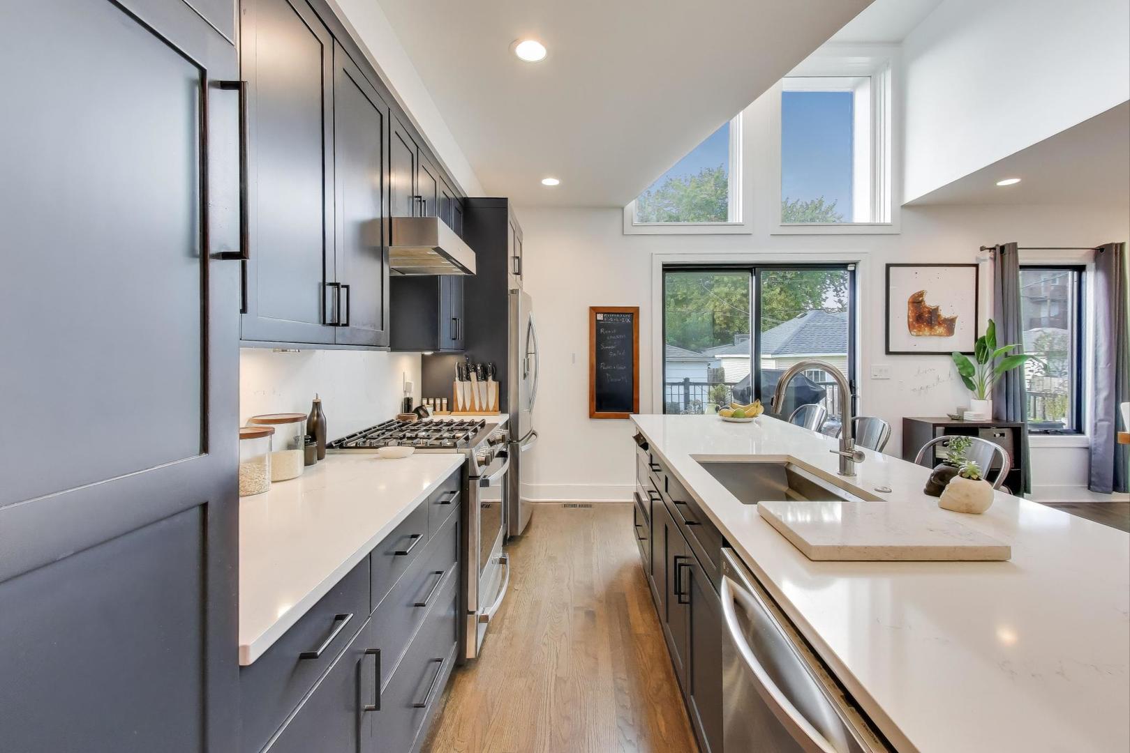 4438 North Spaulding Avenue Chicago, IL 60625 - Photo 13 of 40 a kitchen with stainless steel appliances granite countertop a sink a stove and a refrigerator