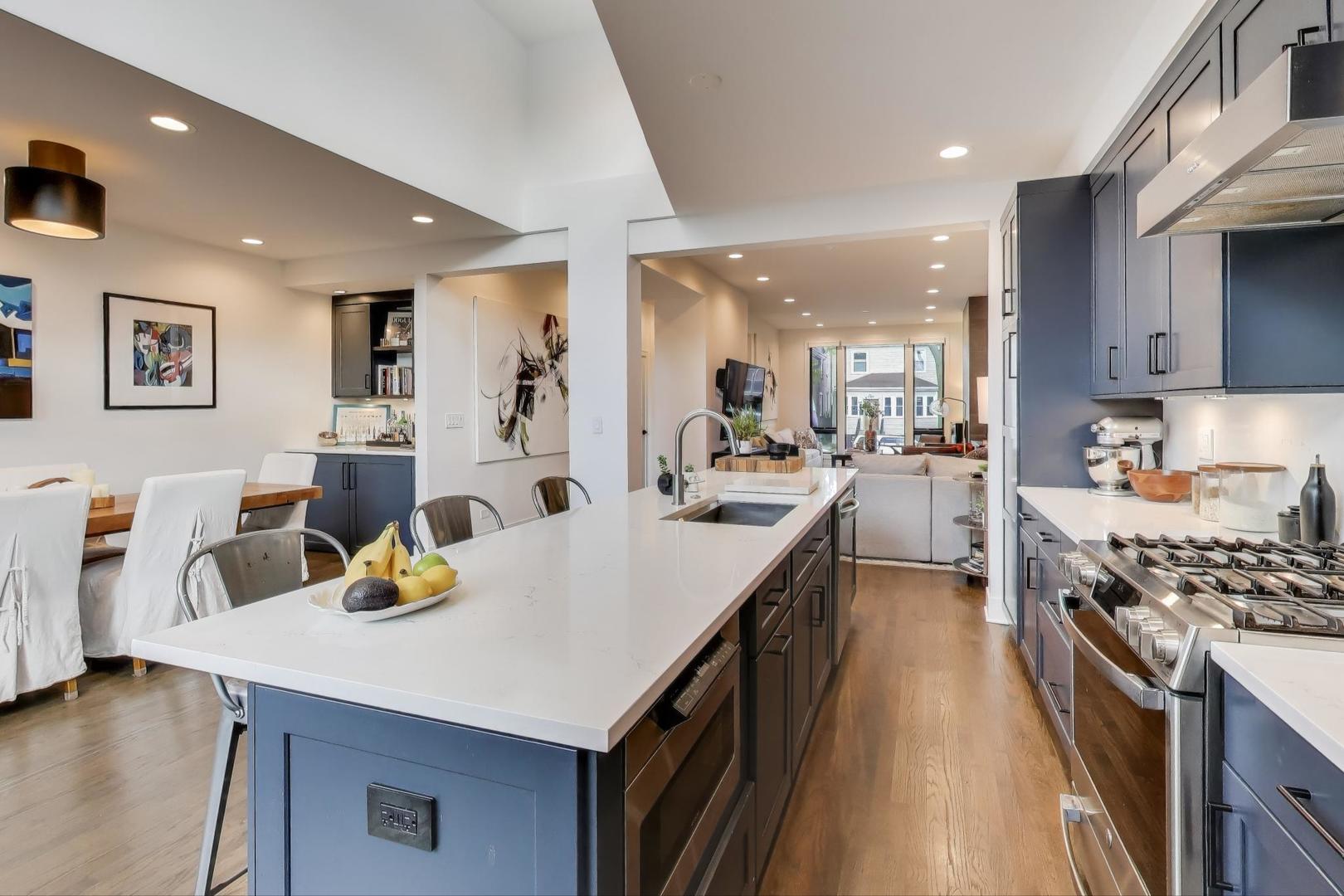 4438 North Spaulding Avenue Chicago, IL 60625 - Photo 14 of 40 a kitchen with a sink a stove and chairs