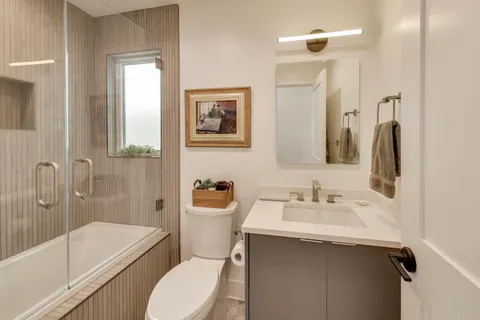 a bathroom with a sink toilet and shower