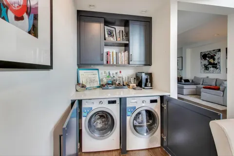 a utility room with sink dryer and washer