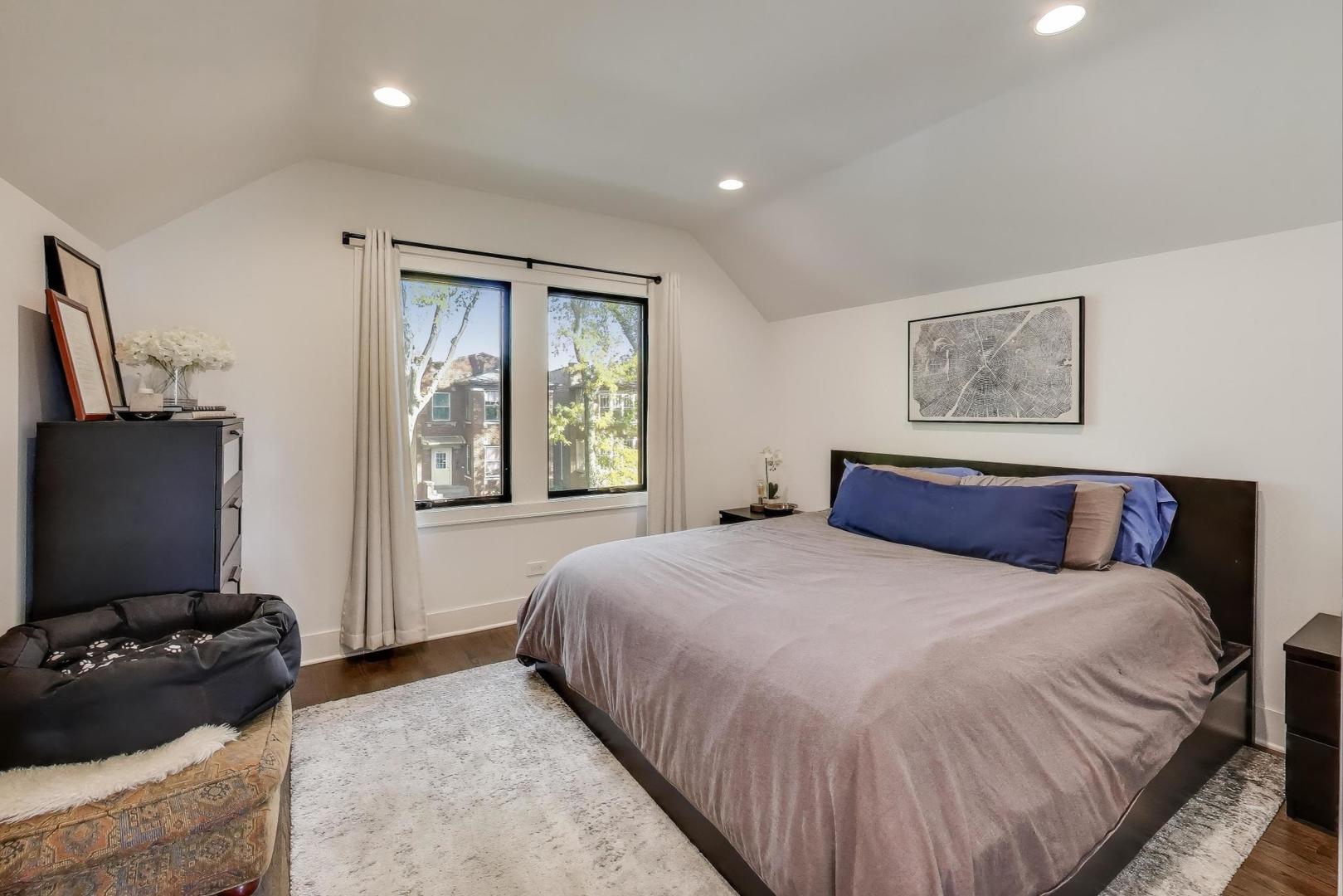 4438 North Spaulding Avenue Chicago, IL 60625 - Photo 17 of 40 a bedroom with a bed and a flat screen tv