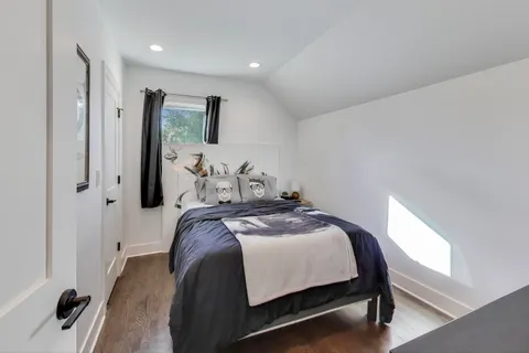 a bedroom with a bed and a mirror